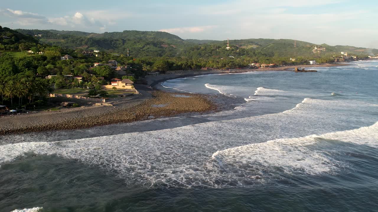 toma aérea de las olas del océano rompiendo la costa, playa el tunco en el salvador, turismo y surf