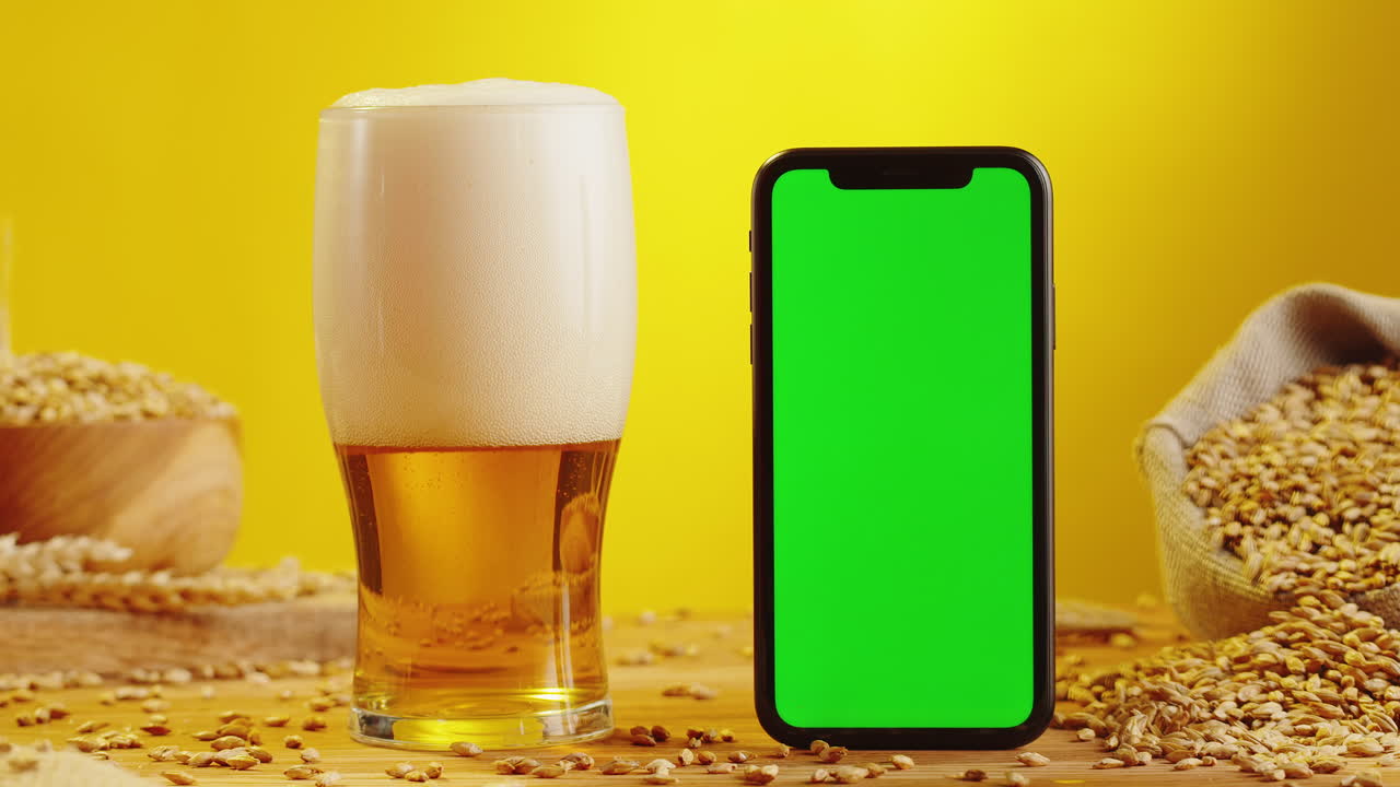 Pouring Beer into Glass with Green Screen Mobile Phone and Barley