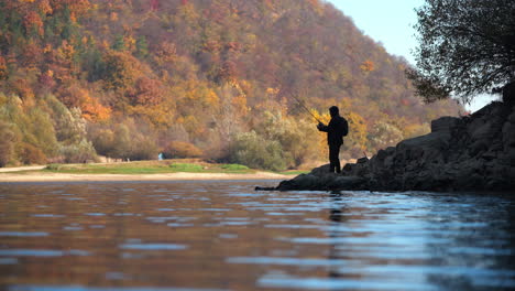 fisherman on a lake in autumn