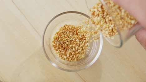 Sesame-Seed-Pouring-Into-A-Glass-Bowl-In-Slow-Motion