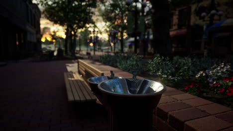 Primer-Plano-De-Una-Fuente-De-Agua-Potable-En-Un-Parque-Al-Atardecer