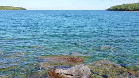 we float over the shores of the crystal clear waters of lake huron on georgian bay, ontario, canada