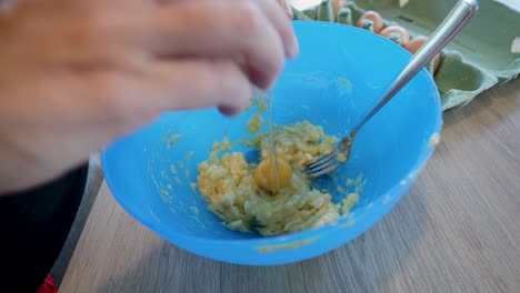 slowmotion shot of fresh eggs being cracked into a bowl to make breakfast