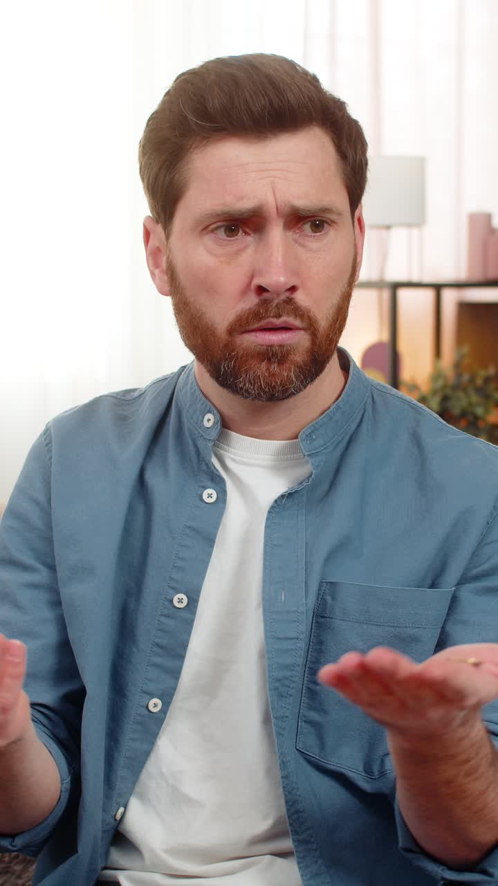 Man shaking piggy bank counting collected coins saving money checking personal finances at home