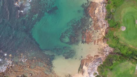 top down view over rugged coastline of little bay beach in sydney, new south wales, australia - drone shot