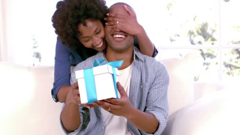 woman offering gift to his boyfriend