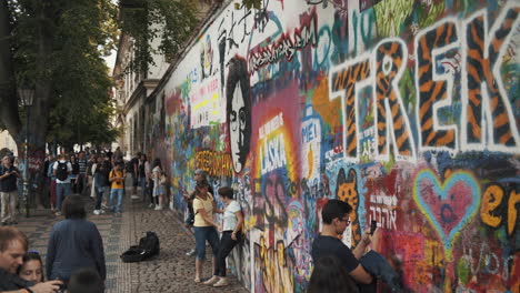 prague, czech republic tourists visiting - the john lennon wall