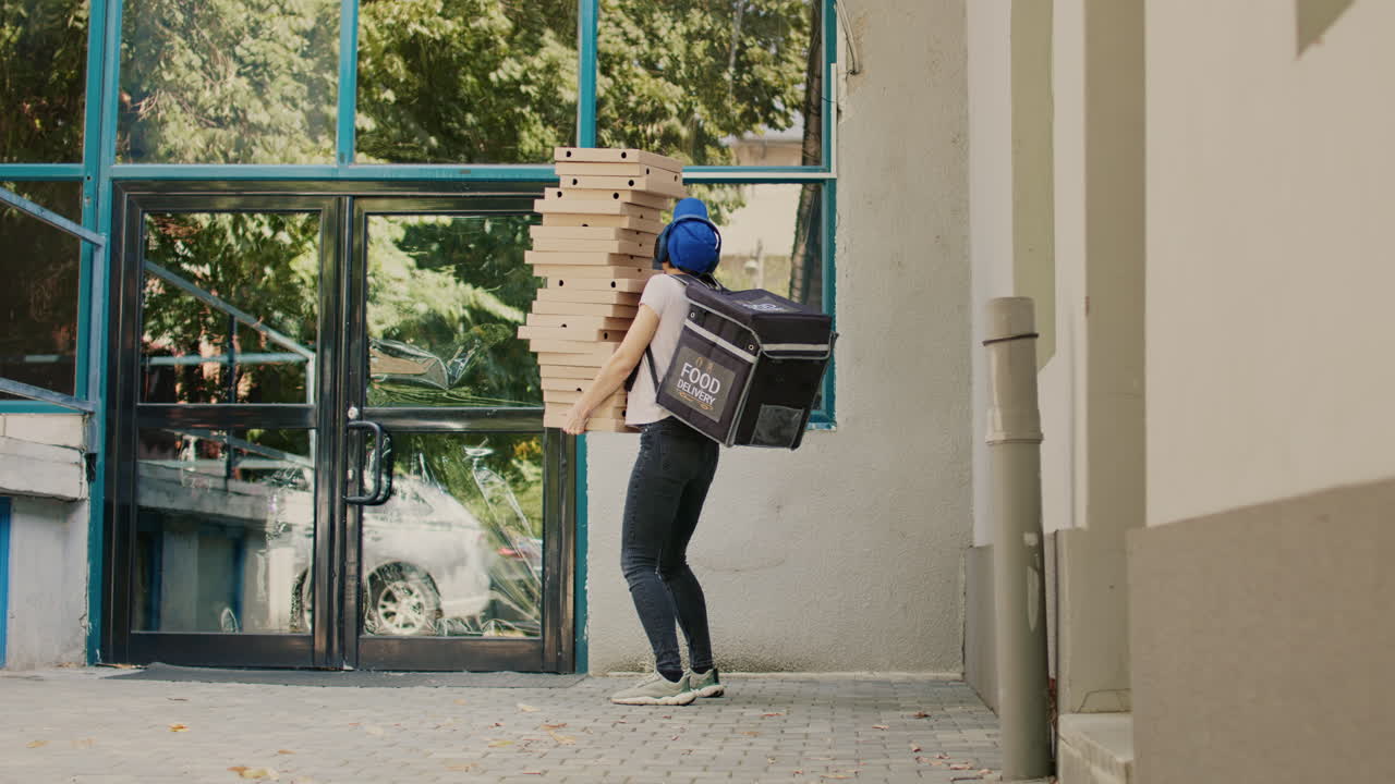 Woman delivering pizza boxes