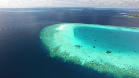 an aerial view shows a sand island on maldives