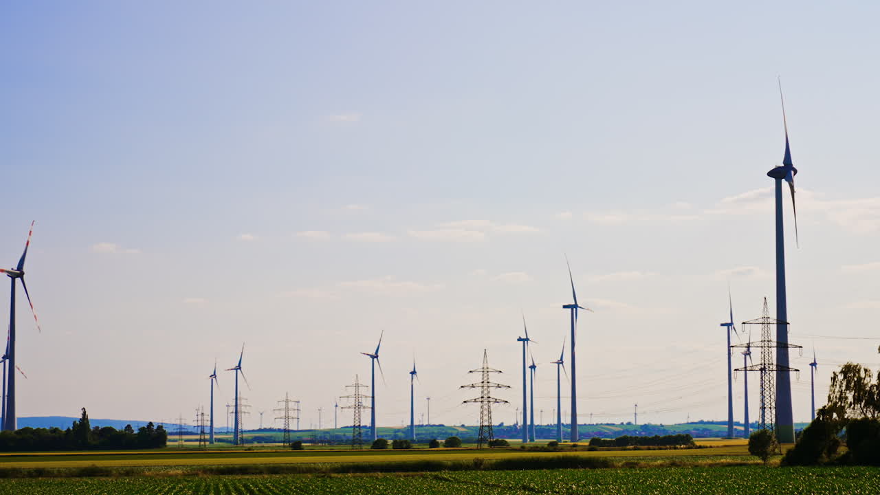 Turbines produce green energy. Vast fields filled with wind turbines showcase renewable energy generation during a clear day in rural areas
