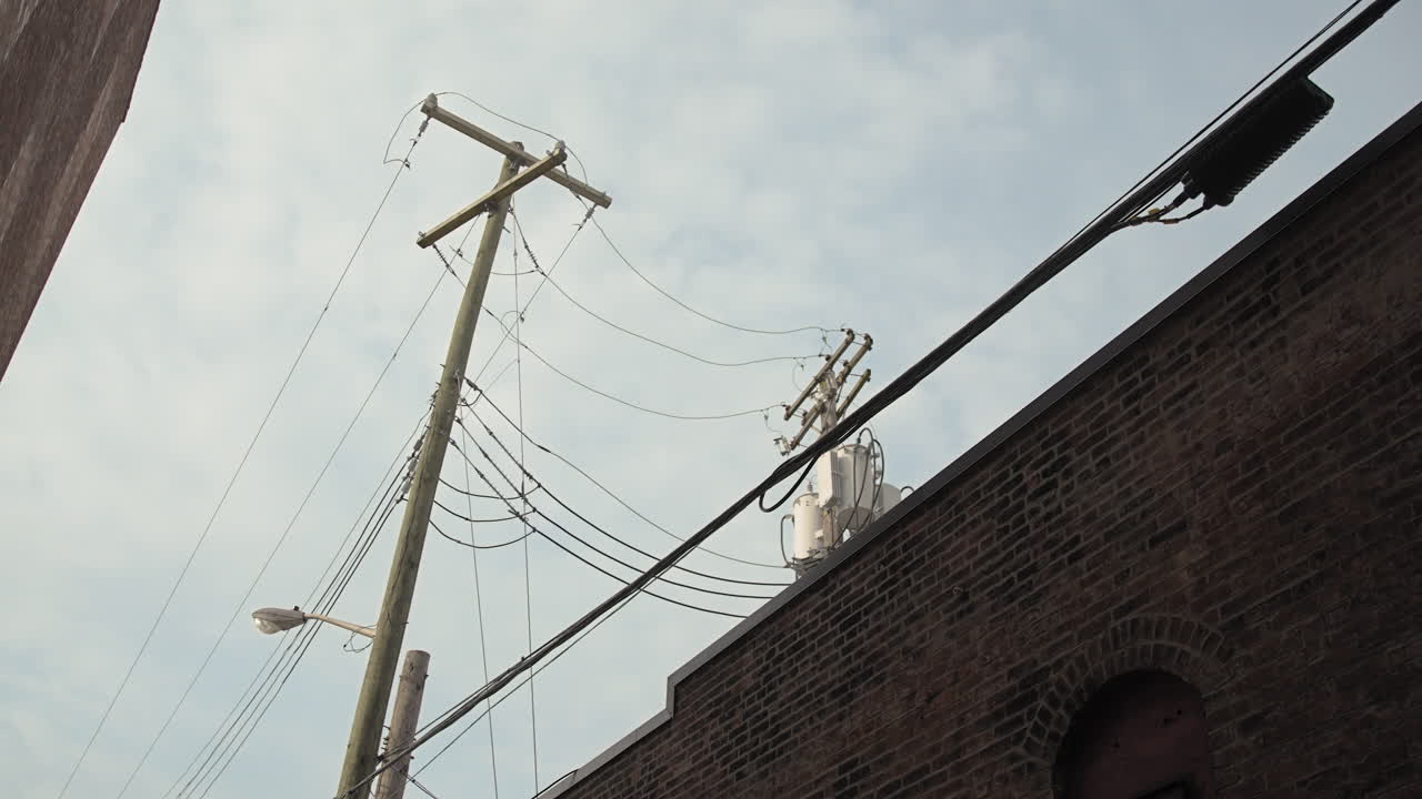 Power Pole Between Two Buildings Looking Up