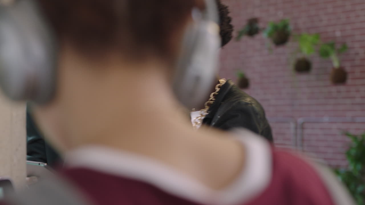 젊은 사업가들이 브레인스토밍을 하고 있습니다. 아프리카계 미국인 팀 리더 여성이 디지털 태블릿 컴퓨터를 사용하여 아이디어를 공유하고 있습니다. 학생들은 다양한 트렌디한 사무실 작업장에서 팀워크를 즐기고 있습니다.