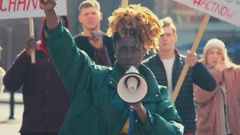 Group-Of-Protestors-With-Placards-And-Megaphone-On-Demonstration-March-Against-Climate-Change