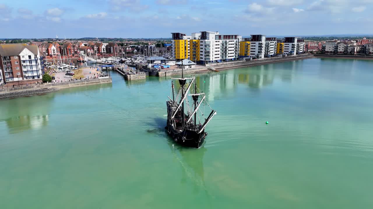 Aerial footage of the majestic Nao Victoria replica as it sails out of port, echoing the spirit of history’s first global circumnavigation.