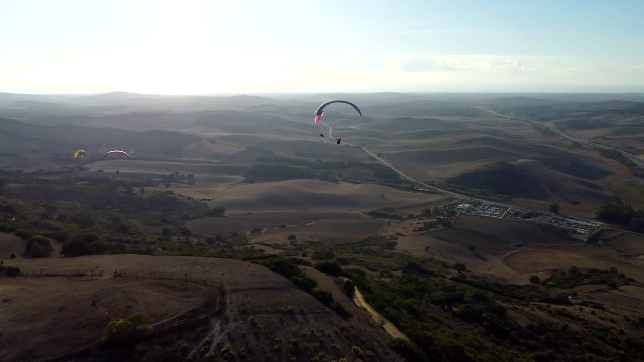 Sunset pan of Paragliders flying in Spain