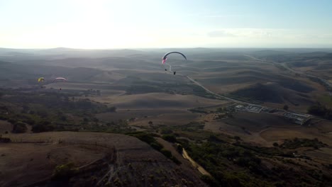 sunset pan of paragliders flying in spain