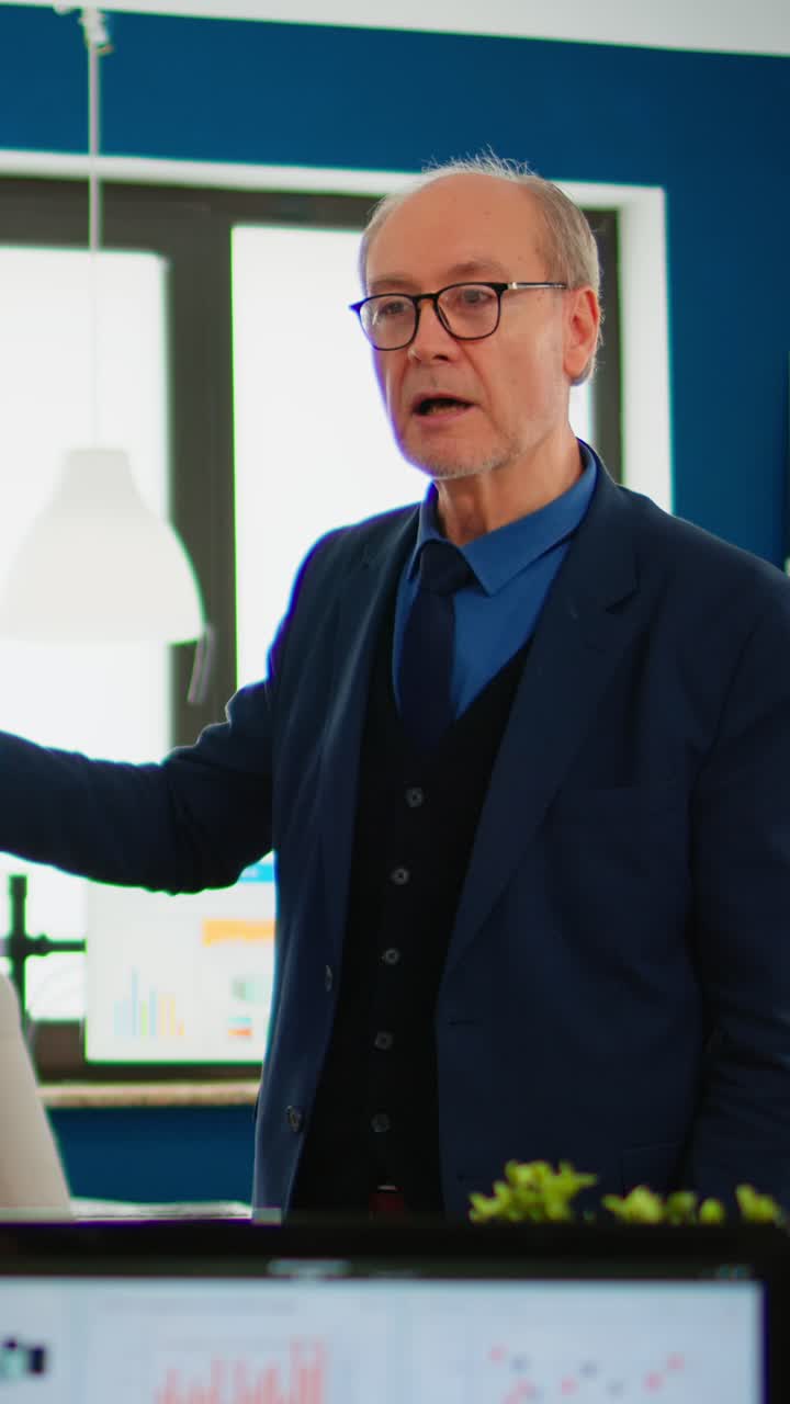 Vertical video Experienced project leader analysing financial presentation during business conference