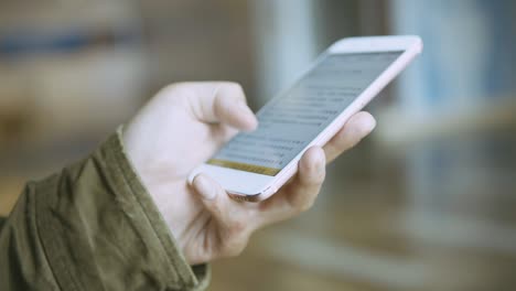 man using smartphone on metro station