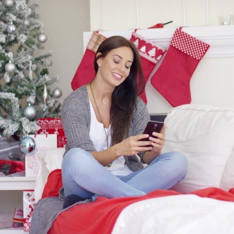 Young-woman-checking-for-Christmas-messages