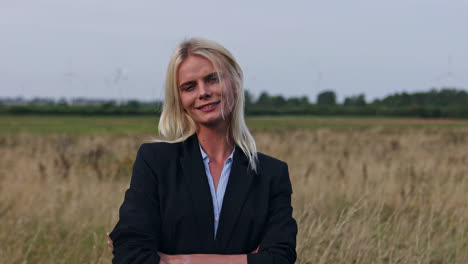 medium shot of caucasian woman in business outfit smiling into camera outside