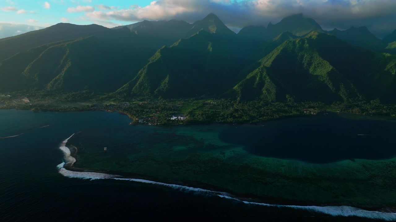 Teahupo'o surf wave lagoon Passe Havea coral reef harbor view Tahiti aerial drone French Polynesia South Pacific Ocean island golden light rays volcano peaks landscape beach coastline forward pan down