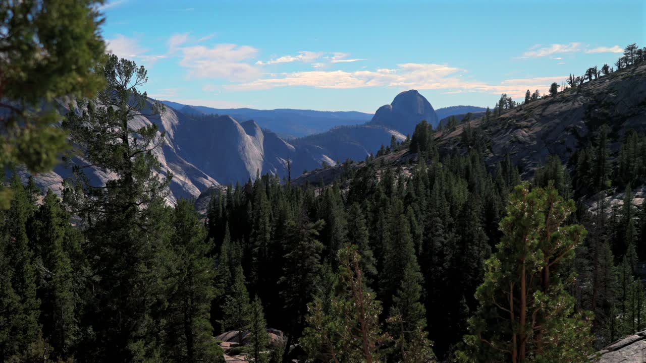 Tioga Pass West Portal Yosemite National Park wilderness forest rugged rocky formation terrain California Lee Vining forest daytime sunny blue sky clouds NP entrance Sierra Nevada Mountains static