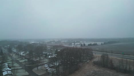 flying towards highway near beautiful lake in snowy weather in warren, ohio, usa