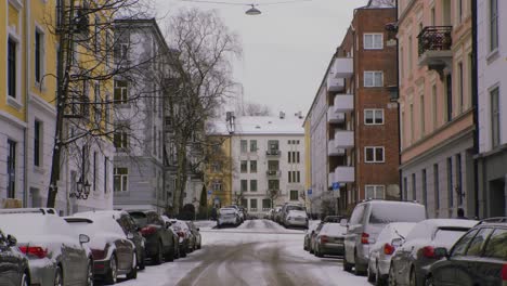 snowy city street in oslo, majorstuen neighborhood with cars, snow, winter