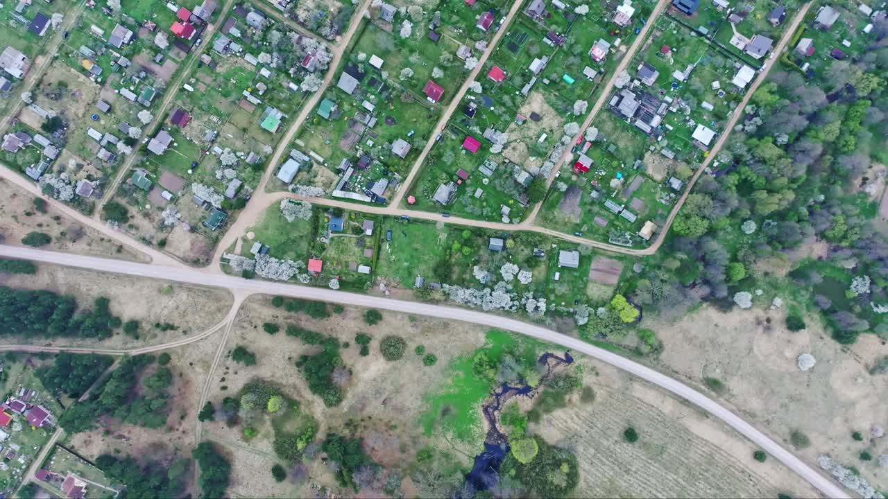 Drone moves forward above Ječi gardens, cloudy spring weather in South Latvia