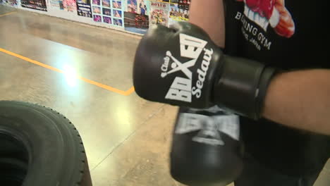 boxing training with gloves and tires