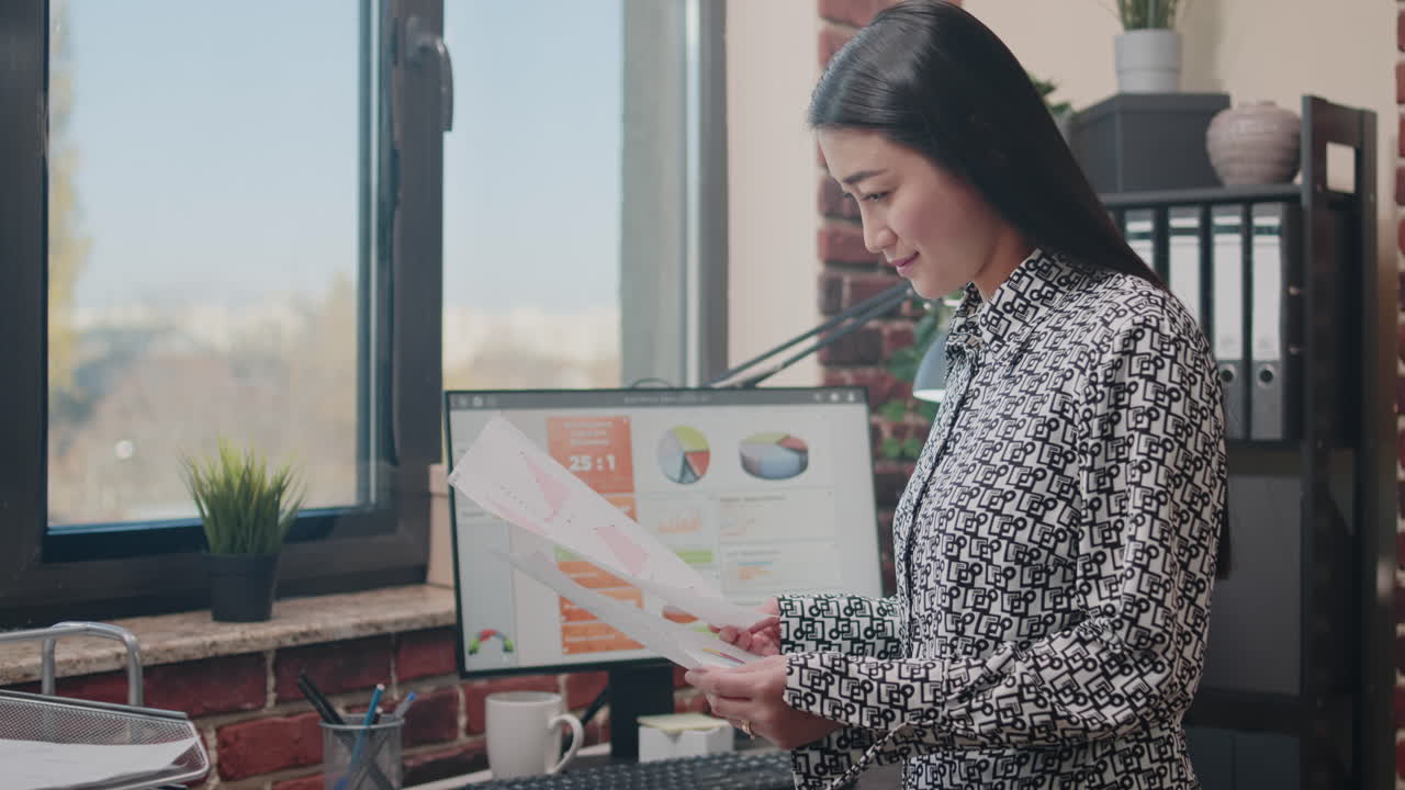 Close up of employee looking at papers with data charts