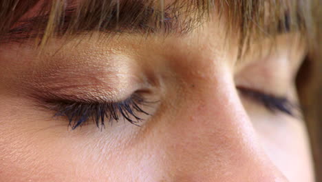 woman opening blue eyes and blinking