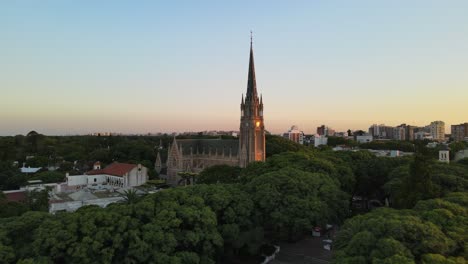 Aerial cinematic shot flying over San Isidro Cathedral at sunset