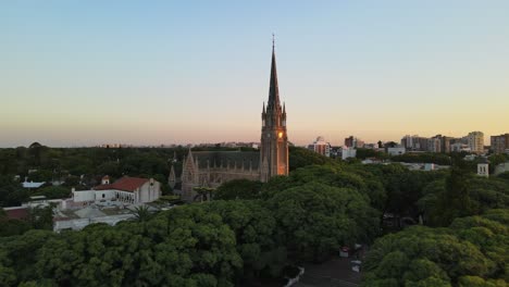 aerial cinematic shot flying over san isidro cathedral at sunset