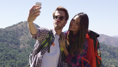 Young-couple-making-selfie-while-hiking