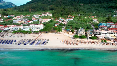 top down view of golden beach after a storm with an algae line close to the beach,lush vegetation, vivid colors, high mountain peaks, thassos island, greece, europe