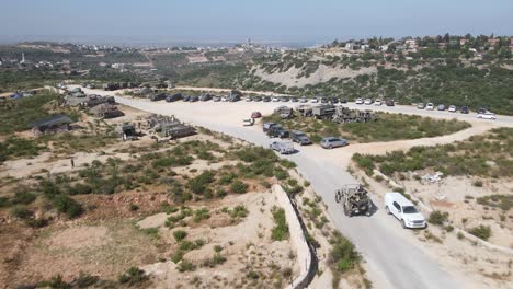 army trucks driving on dirt road, aerial view