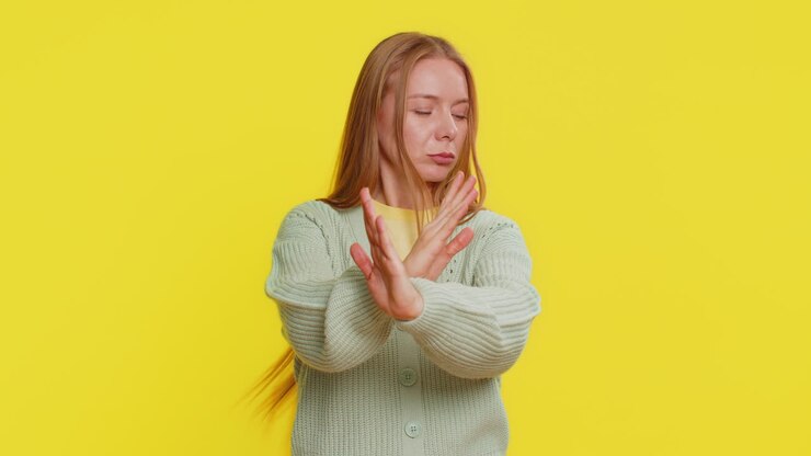 Annoyed irritated woman covering ears gesturing no avoiding advice ignoring noise loud voices