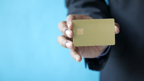 hand holding gold credit card