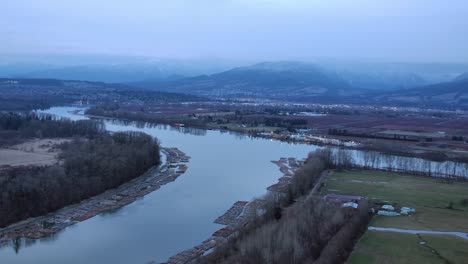 Timber-Rafting-on-River-Aerial-View-at-Dusk