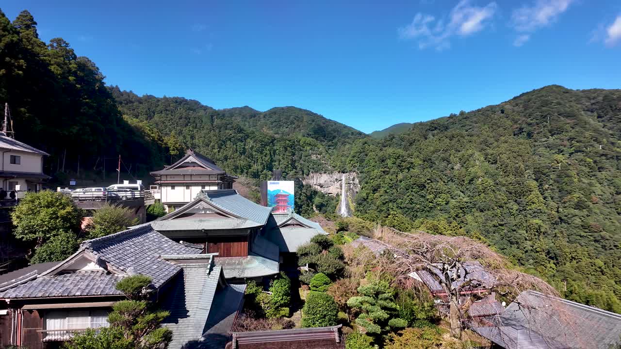 Stunning view of Seigantoji Temple and the Nachi no Taki waterfall nestled in the lush green mountains of Nachikatsuura, Japan