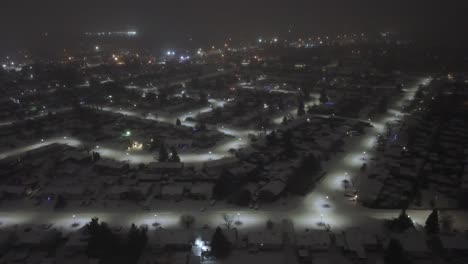 snow covered residential neighborhood in st constant, quebec, canada, illuminated by street lights at night