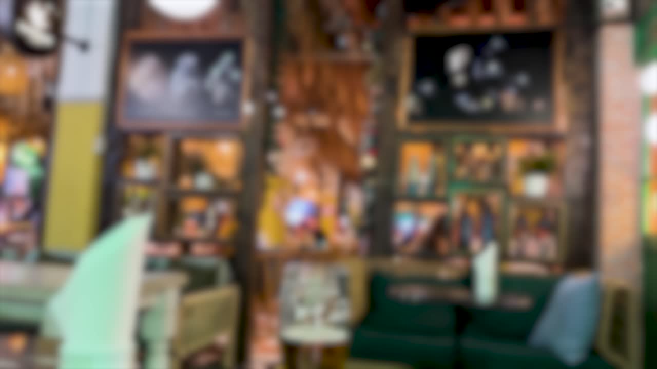 A vibrant, blurred view of an outdoor restaurant with dynamic lighting and colorful decor, creating a lively atmosphere