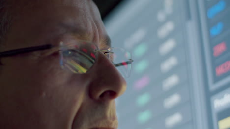 Closeup-Of-Pensive-Data-Engineer-With-Eyeglasses-Looking-At-Digital-Monitor