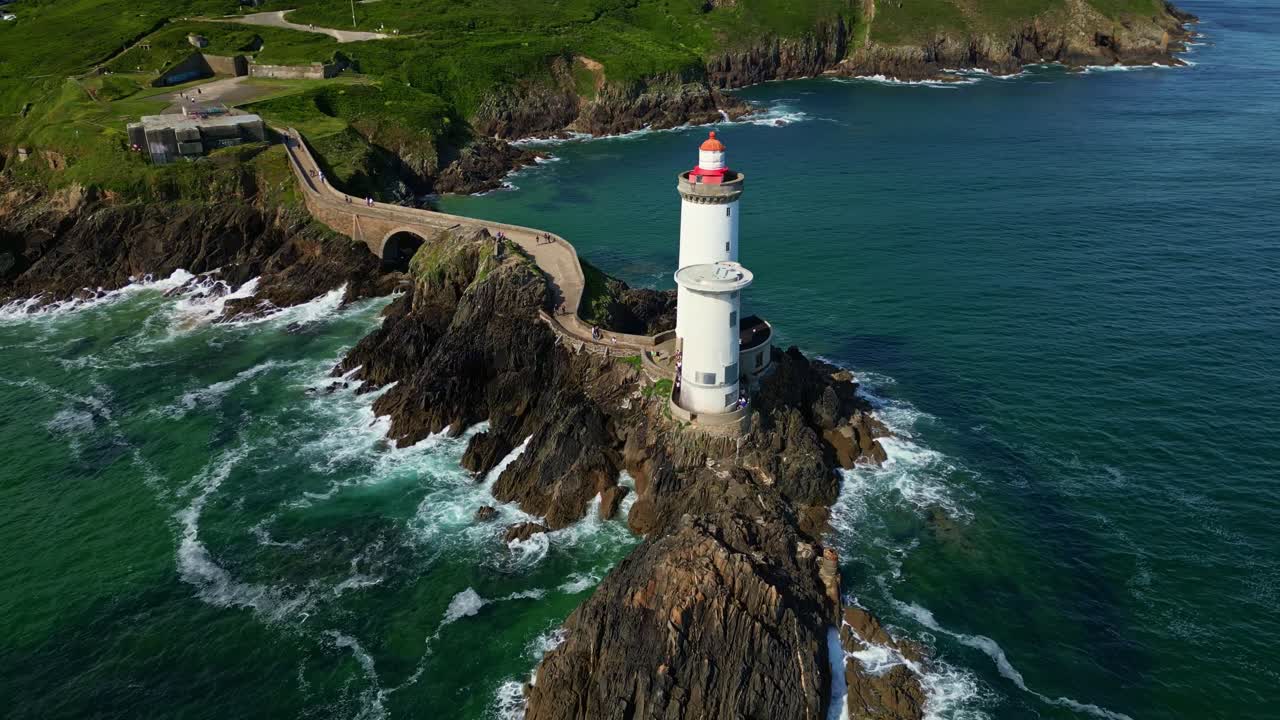 Petit Minou Lighthouse on rocky coast, France. Aerial drone orbiting