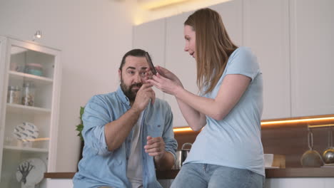 Attractive-Woman-Gets-Angry-Looking-At-Her-Bearded-Partner's-Cell-Phone-1