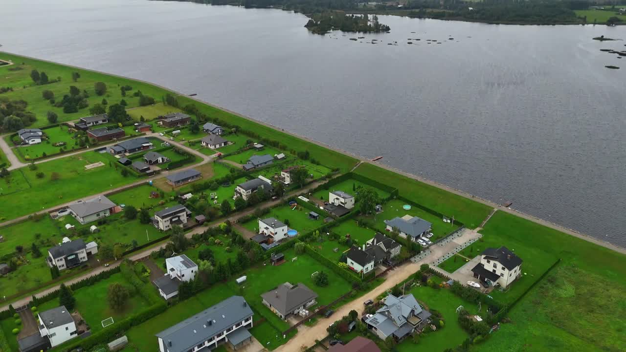 Daugava River With Traquil Water Seen From Ikskile Town In Ogre, Vidzeme, Latvia. - aerial tilt up shot
