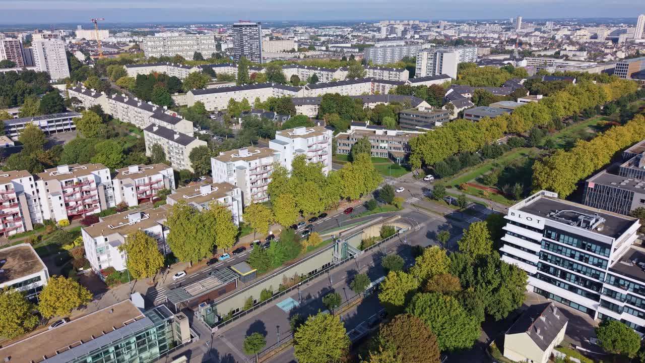 Drone pans above Rennes showing Henri Fréville district, traffic, trees and residential buildings