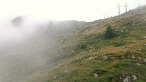 Drone-Flying-Over-Foggy-Mountain-Landscape-In-Passo-San-Marco,-Northern-Italy-During-Daytime---aerial-drone-shot