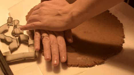 Cutting-out-halloween-themed-cookies-from-rolled-caramel-dough